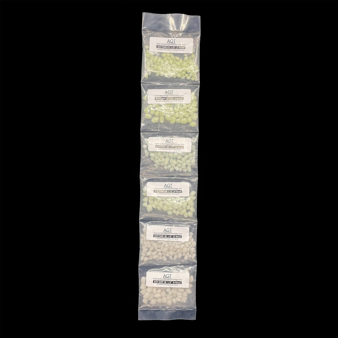 Sample Strip of AGT™ Glowing Mini Pebbles in Emerald Yellow, Aqua Blue and Sky Blue in both 1/4" and 1/8" sizes. Day time view.
