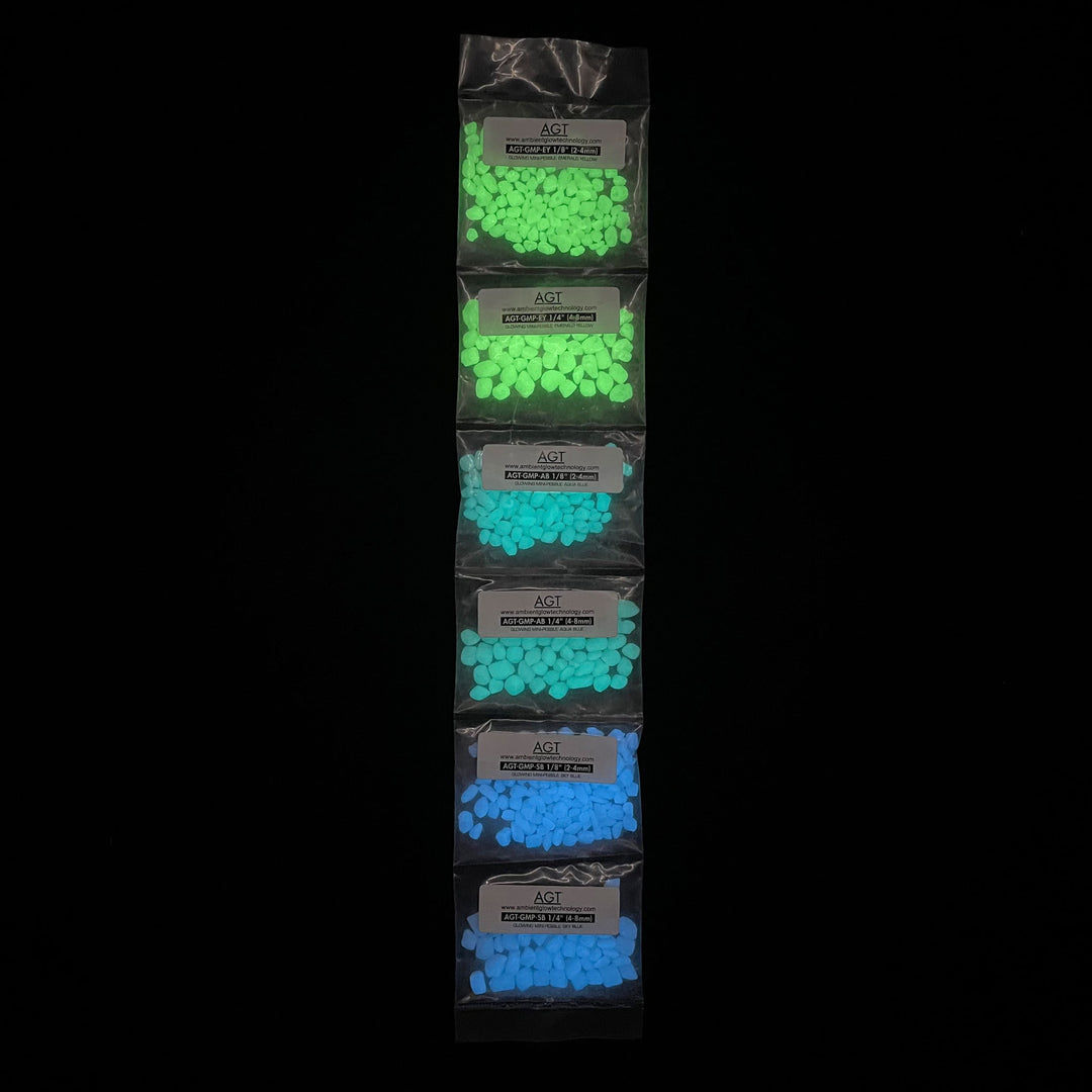 Sample Strip of AGT™ Glowing Mini Pebbles in Emerald Yellow, Aqua Blue and Sky Blue in both 1/4" and 1/8" sizes. Glow in the dark pebbles.