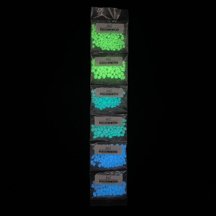 Sample Strip of AGT™ Glowing Mini Pebbles in Emerald Yellow, Aqua Blue and Sky Blue in both 1/4" and 1/8" sizes. Glow in the dark pebbles.