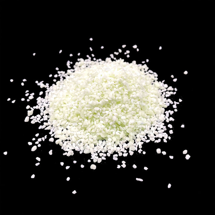 A day time view of a pile of AGT™ Resin Glow Sand in Safety Yellow.