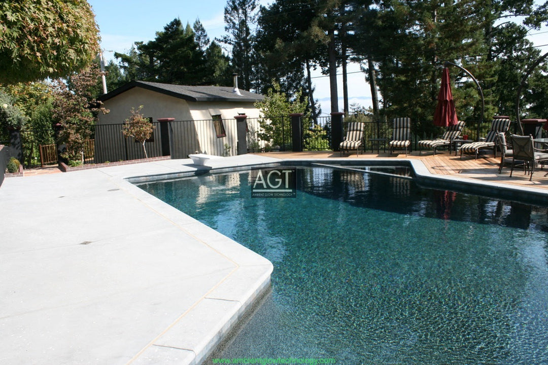 Glowing concrete pool deck Powered by AGT™ Commercial-Grade 1/2" Glow Stone in Sky Blue & Aqua Blue during the day