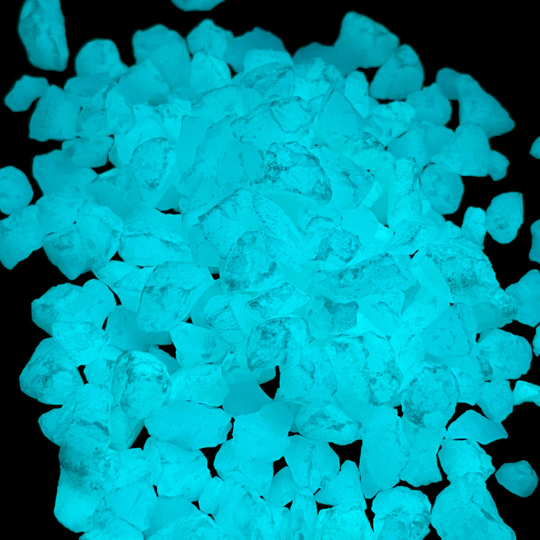Close up view of a pile of glowing Aqua Blue Ultra Grade Glow Stones