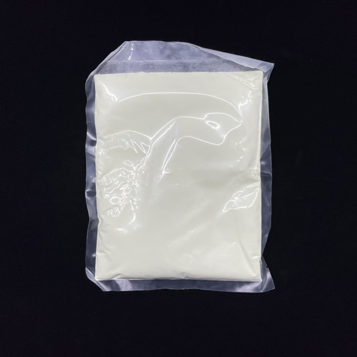 A bag of our high performance, AGT™ Safety Yellow Fine Glow Sand featuring best-in-class glow performance and an encapsulated particle matrix. Day time view.