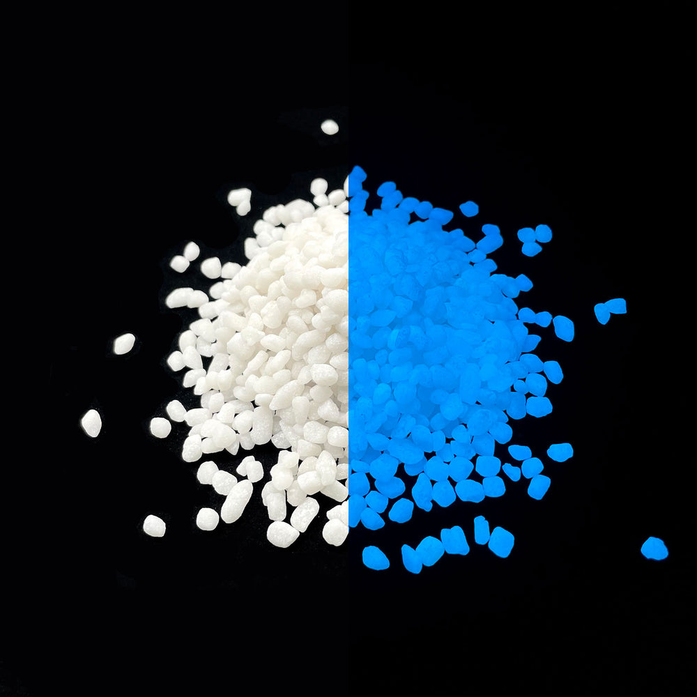Side by side glow in the dark comparison of AGT™ Sky Blue Mini Pebbles. Larger pile.